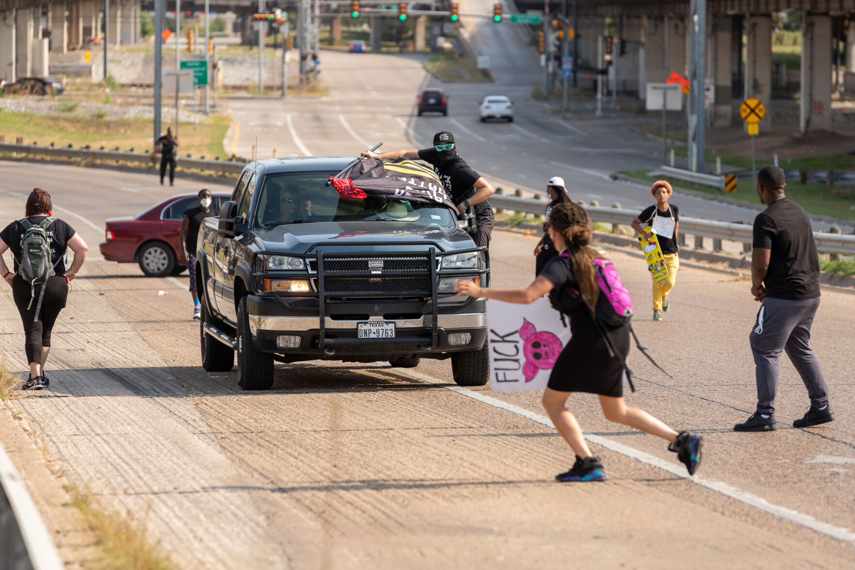 Photos: Protesters march down U.S. 75, chant outside home of Dallas mayor to call for racial justice